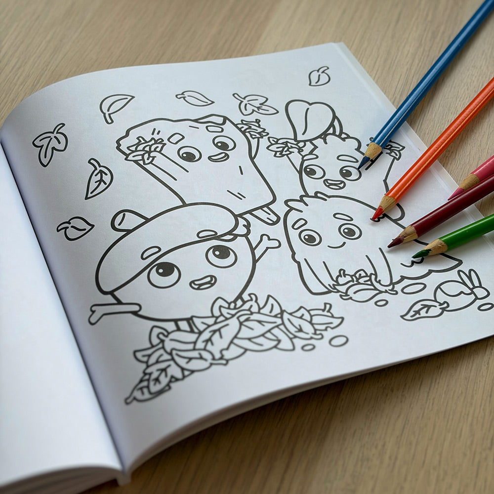 Coloring book page with Zip and the Tiny Sprouts cartoon characters and colored pencils lying on a wooden table